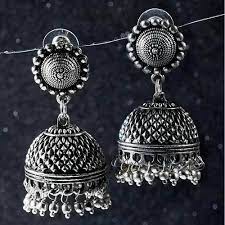 a pair of silver bells hanging from a line