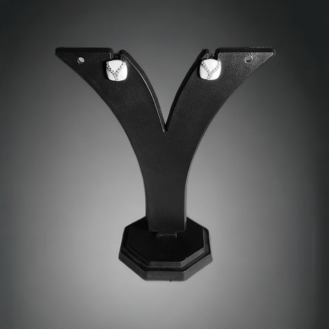a pair of black earrings sitting on top of a black stand