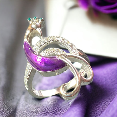 a close up of a ring on a purple cloth