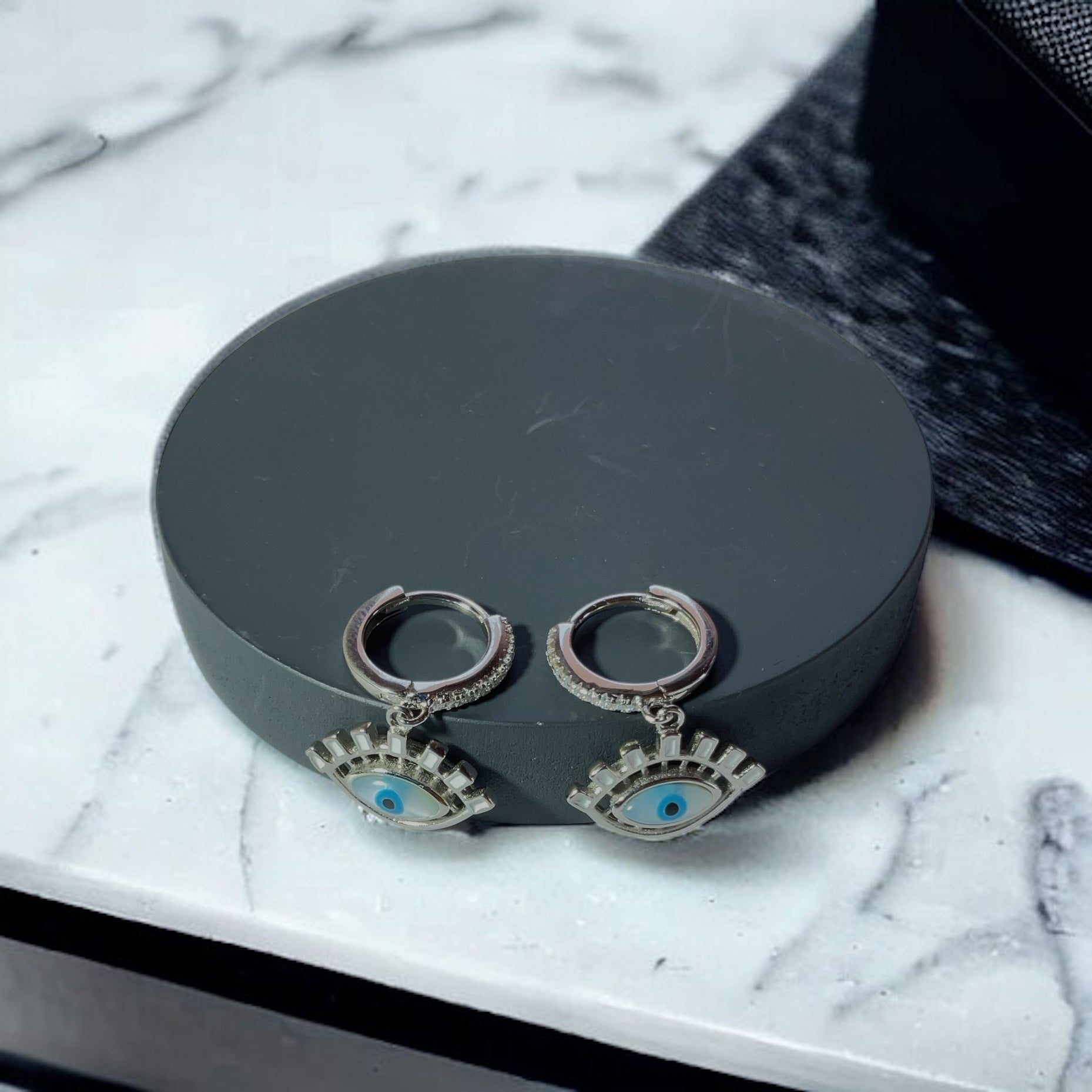 a pair of earrings sitting on top of a table