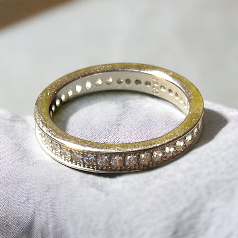 a close up of a wedding ring on a white cloth