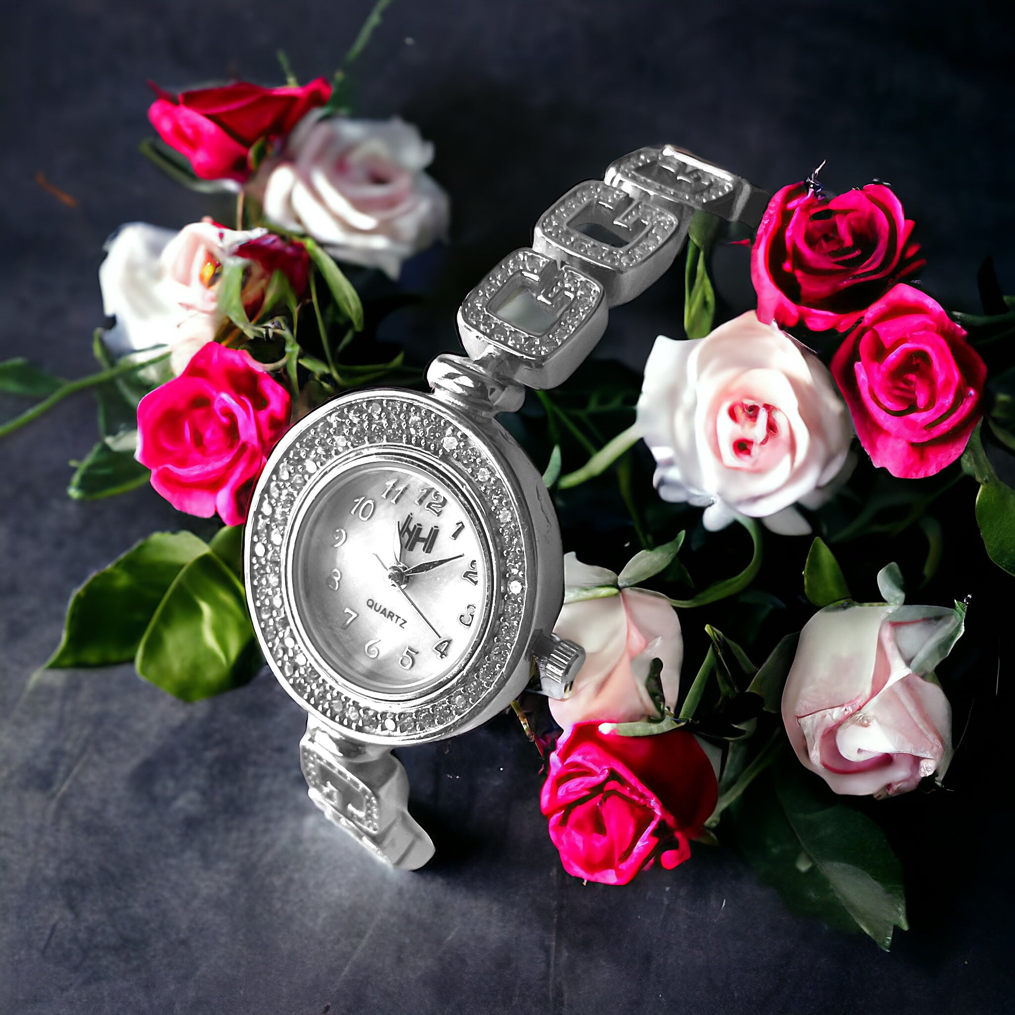 a watch surrounded by pink and white roses