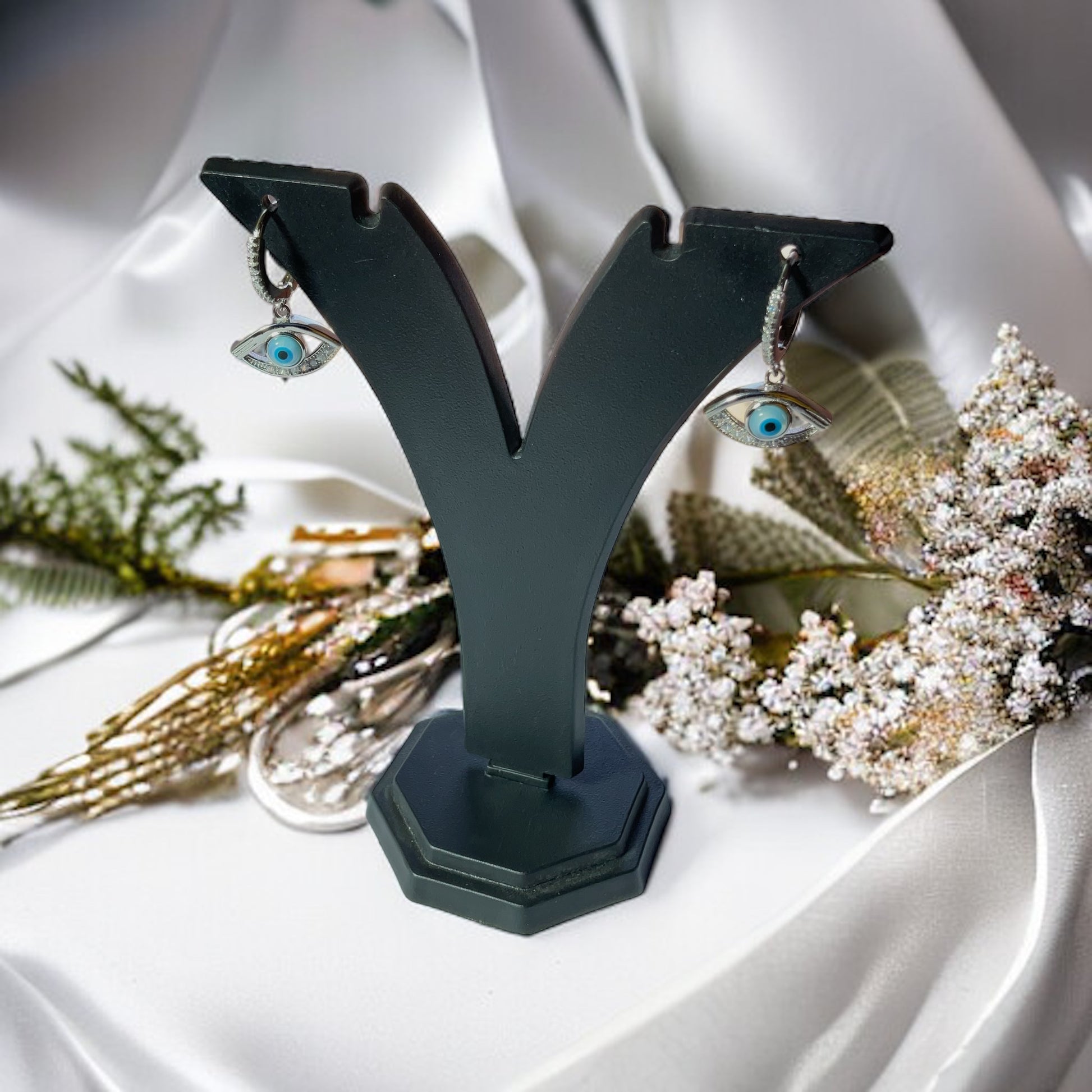 a pair of earrings sitting on top of a table