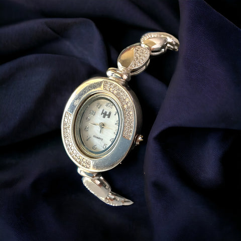 a close up of a watch on a cloth