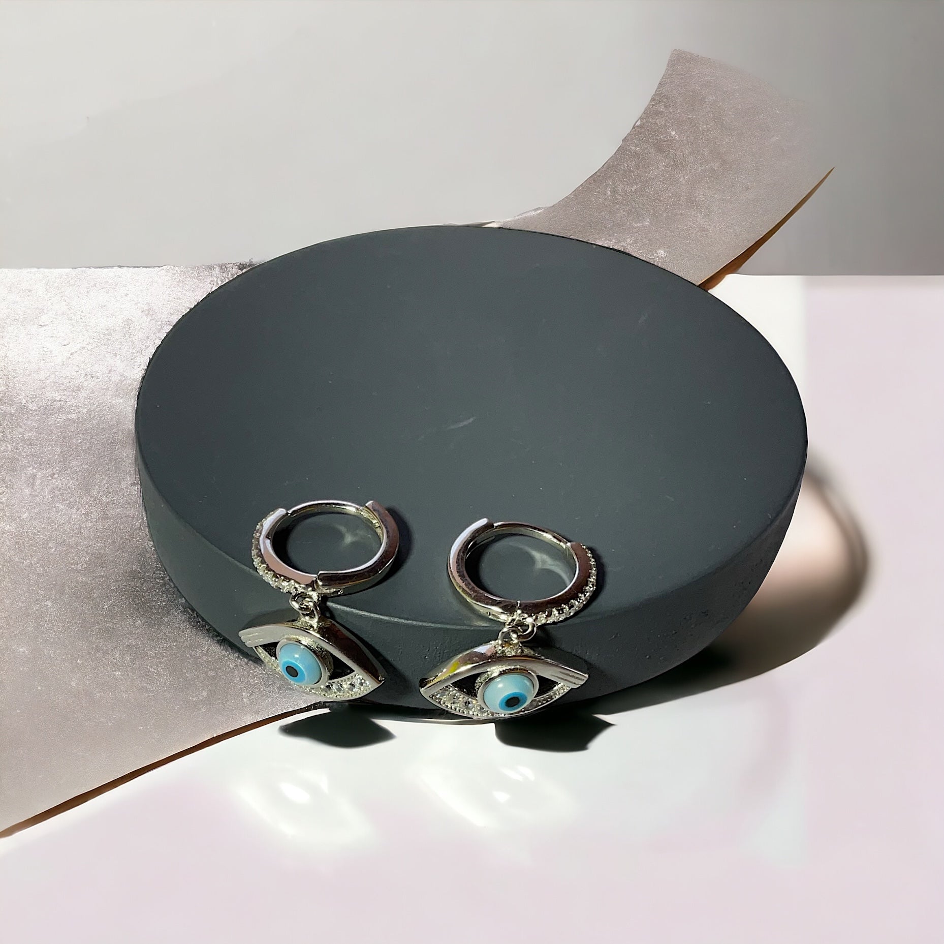 a pair of earrings sitting on top of a box