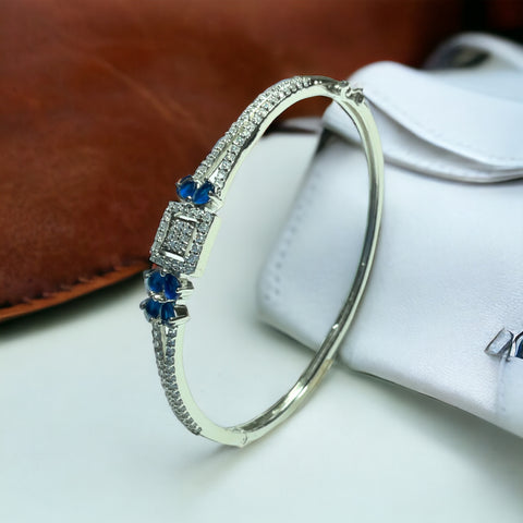 a white gold bracelet with blue sapphires and diamonds