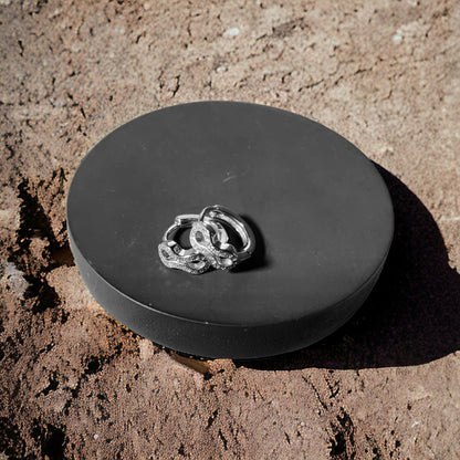 a couple of wedding rings sitting on top of a black box