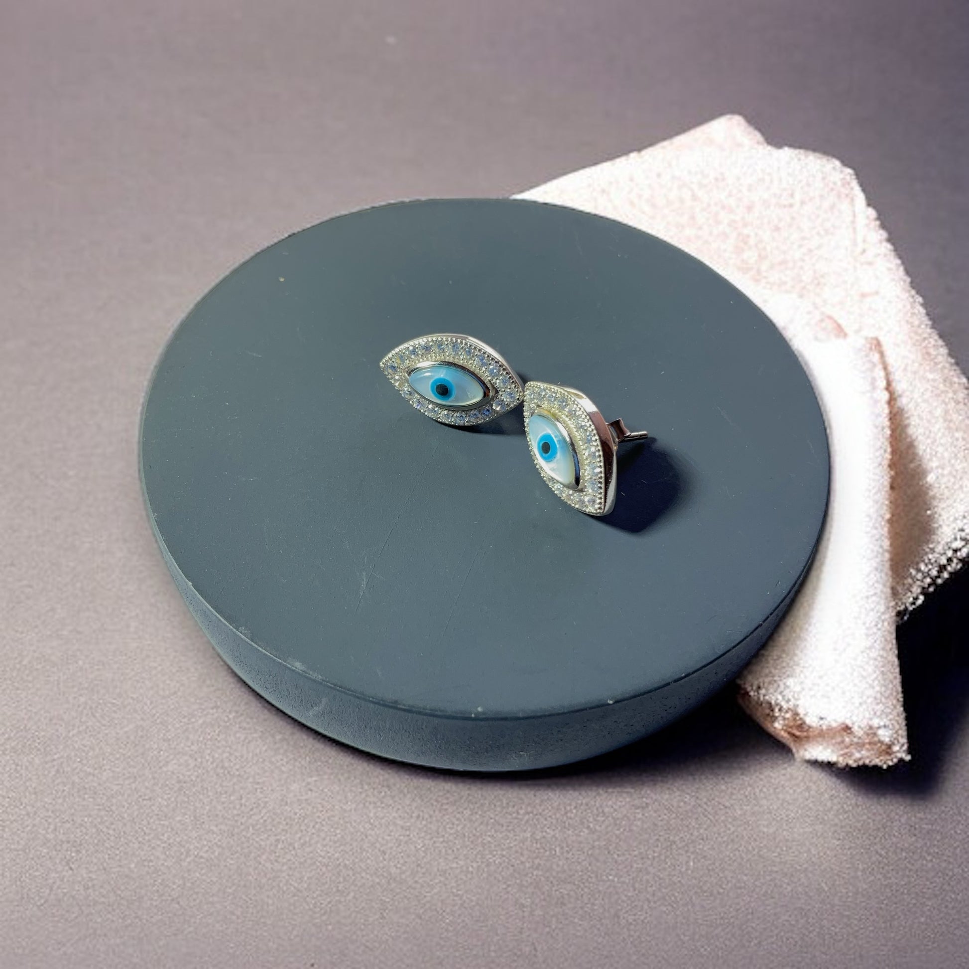 a pair of earrings sitting on top of a table