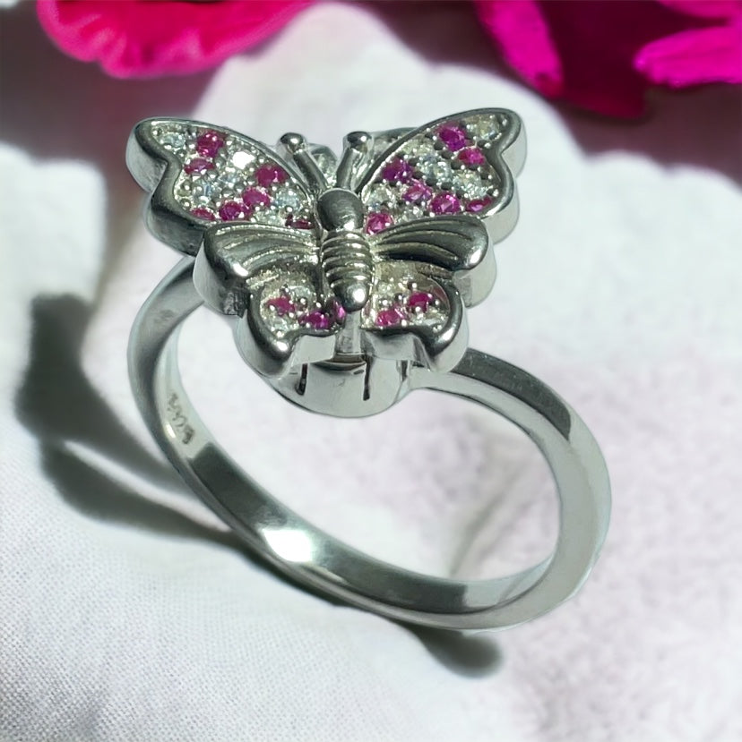 a ring with a butterfly on top of it