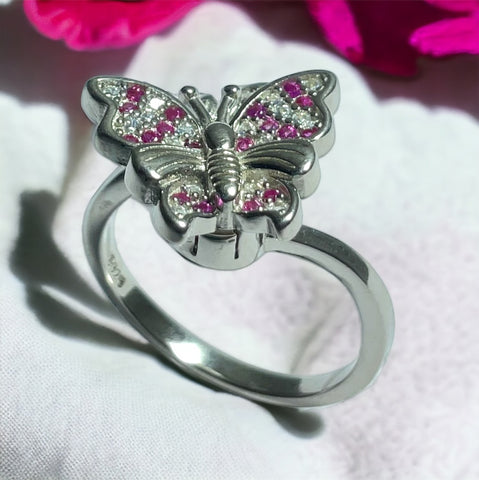 a ring with a butterfly on top of it