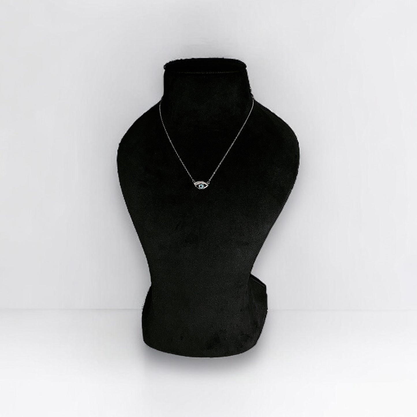 a black mannequin with a necklace on it