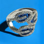 a silver ring with blue stones on a blue background