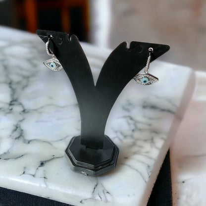 a pair of earrings on a marble table