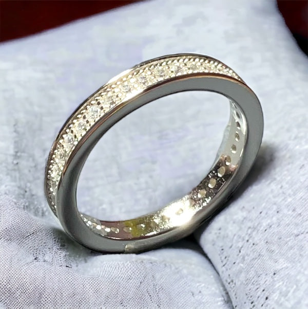 a close up of a wedding ring on a white cloth