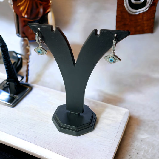 a pair of earrings is on display on a table