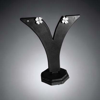 a pair of black earrings with white flowers on them