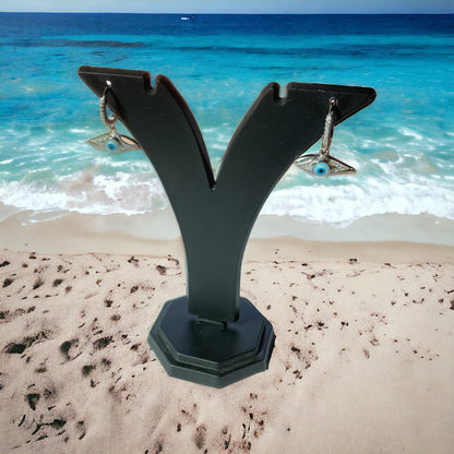 a sculpture of a letter v on a beach