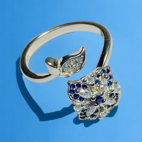 a diamond and sapphire ring on a blue background