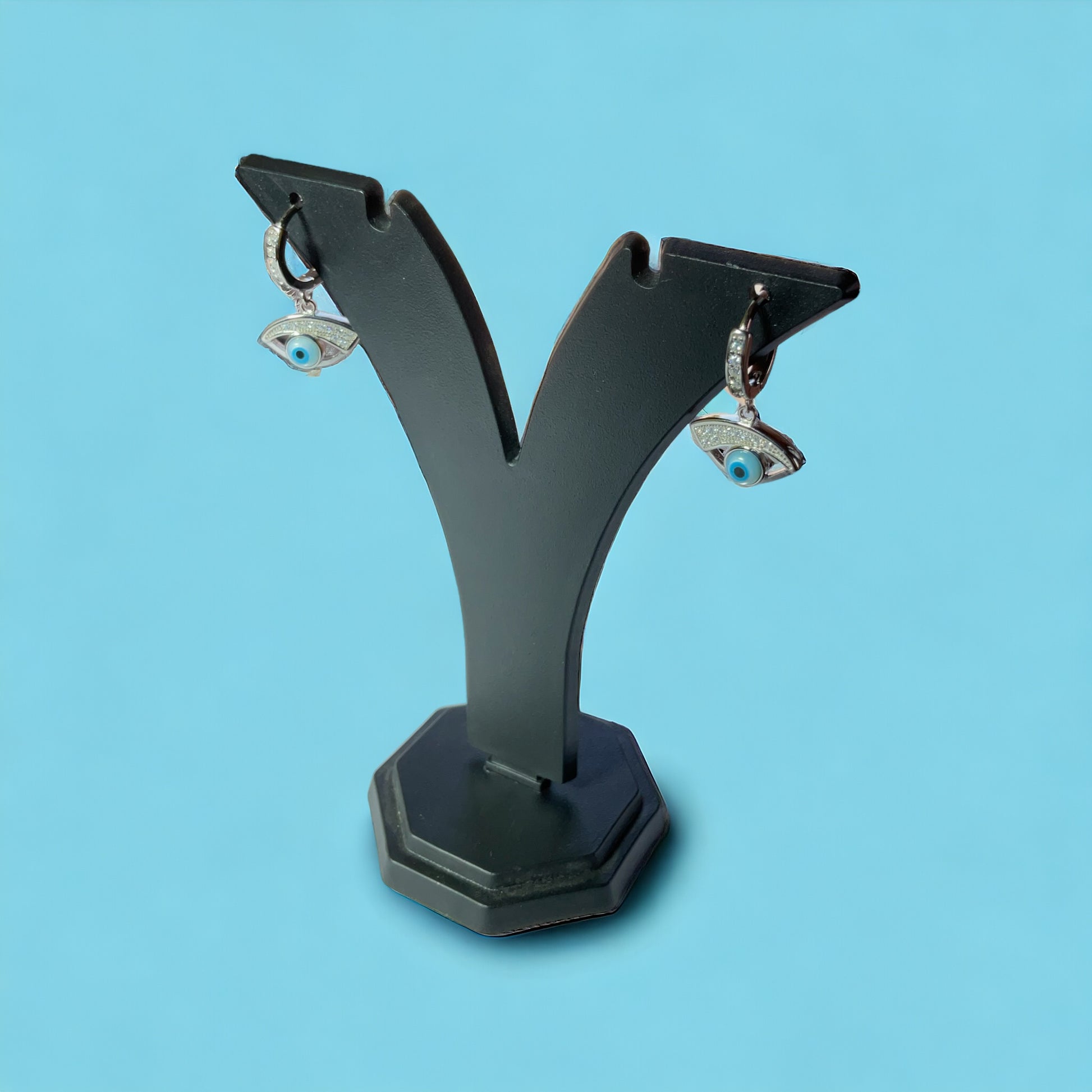 a pair of earring stands on a blue background