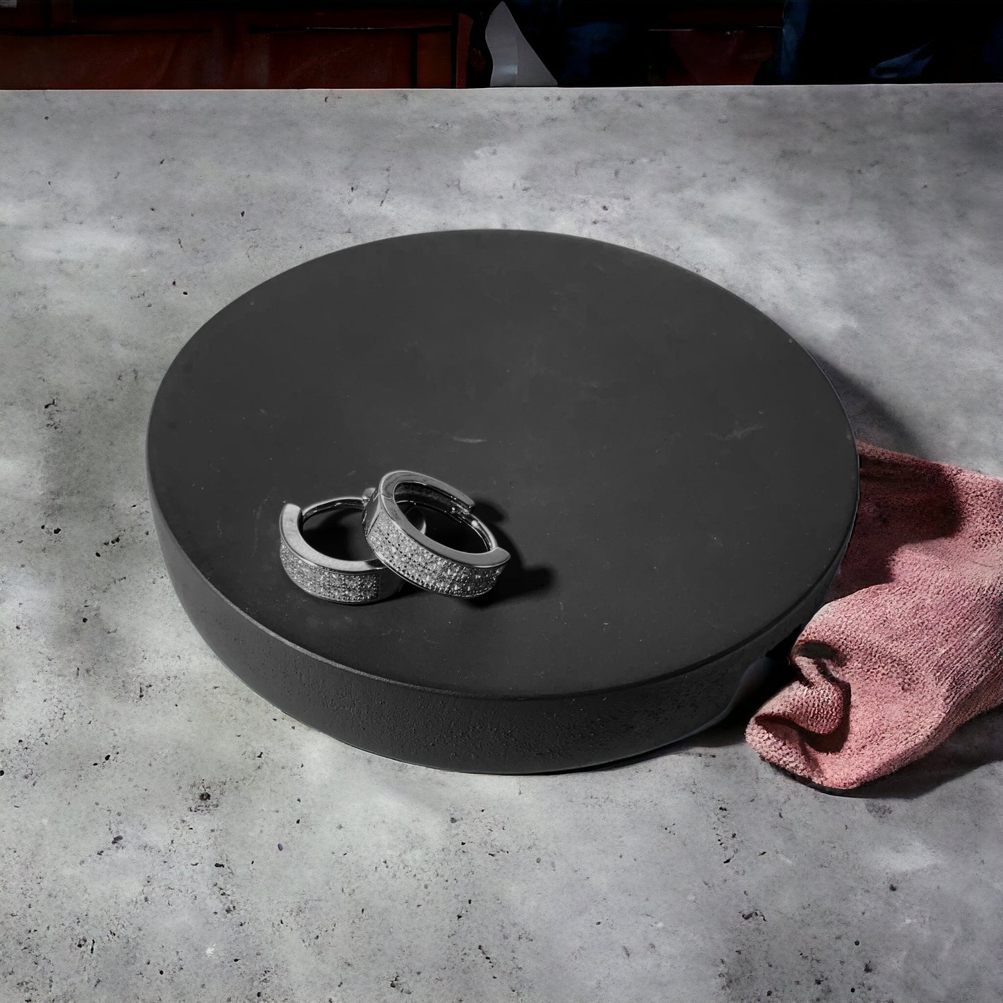 a pair of wedding rings sitting on top of a black box