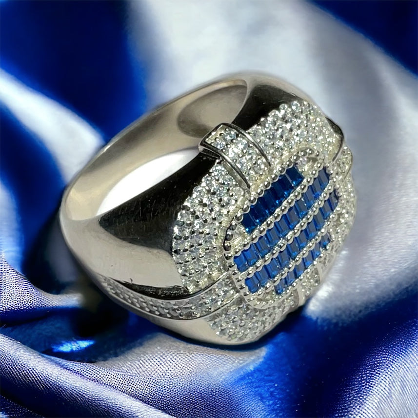 a silver ring with blue and white diamonds