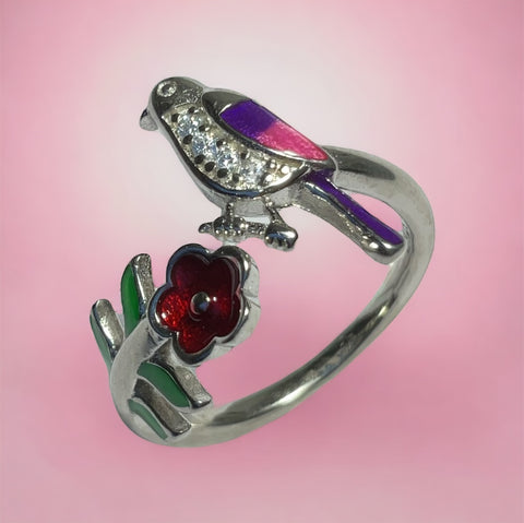 a silver ring with a bird on top of it