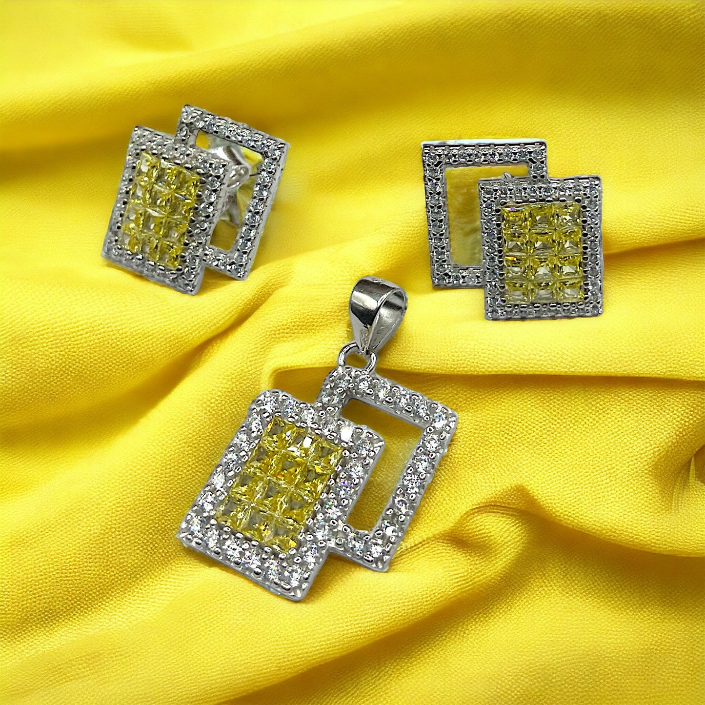 a pair of yellow and white diamond earrings