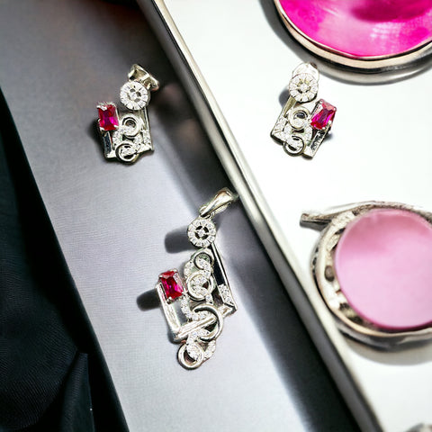 a close up of a pair of earrings in a box