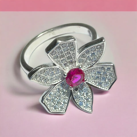 a close up of a ring with a flower on it