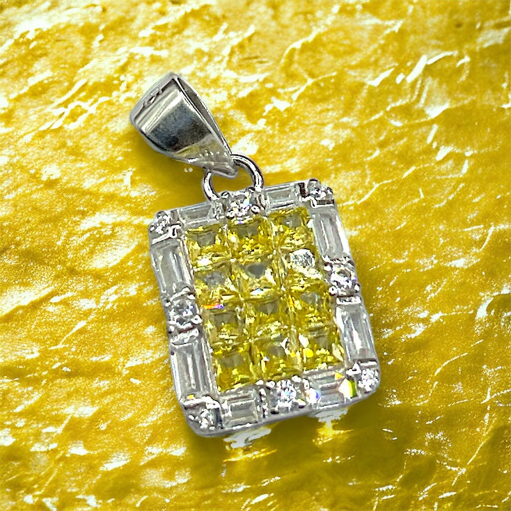 a yellow diamond pendant on a yellow surface