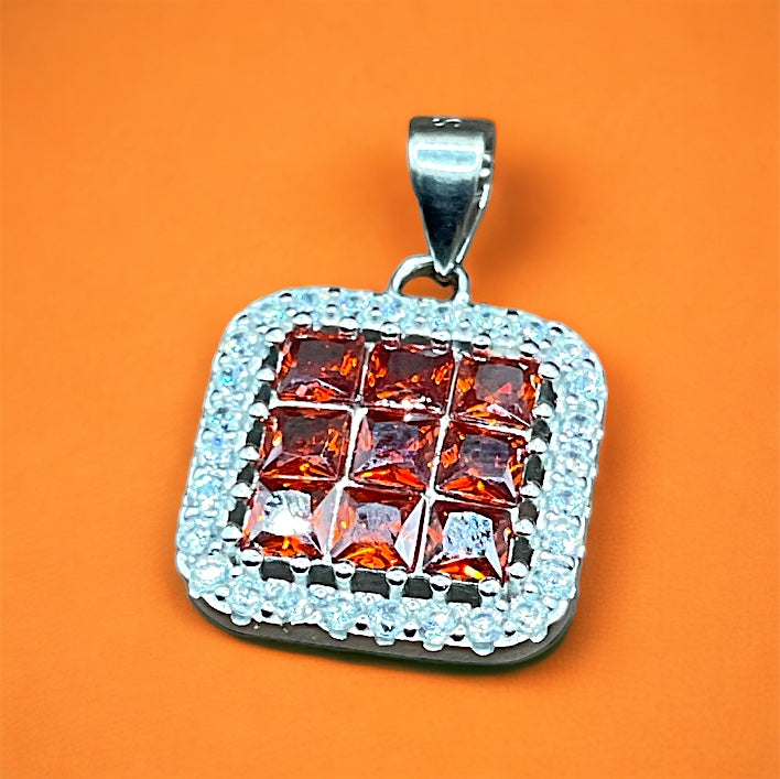 a square pendant with a square design on an orange background
