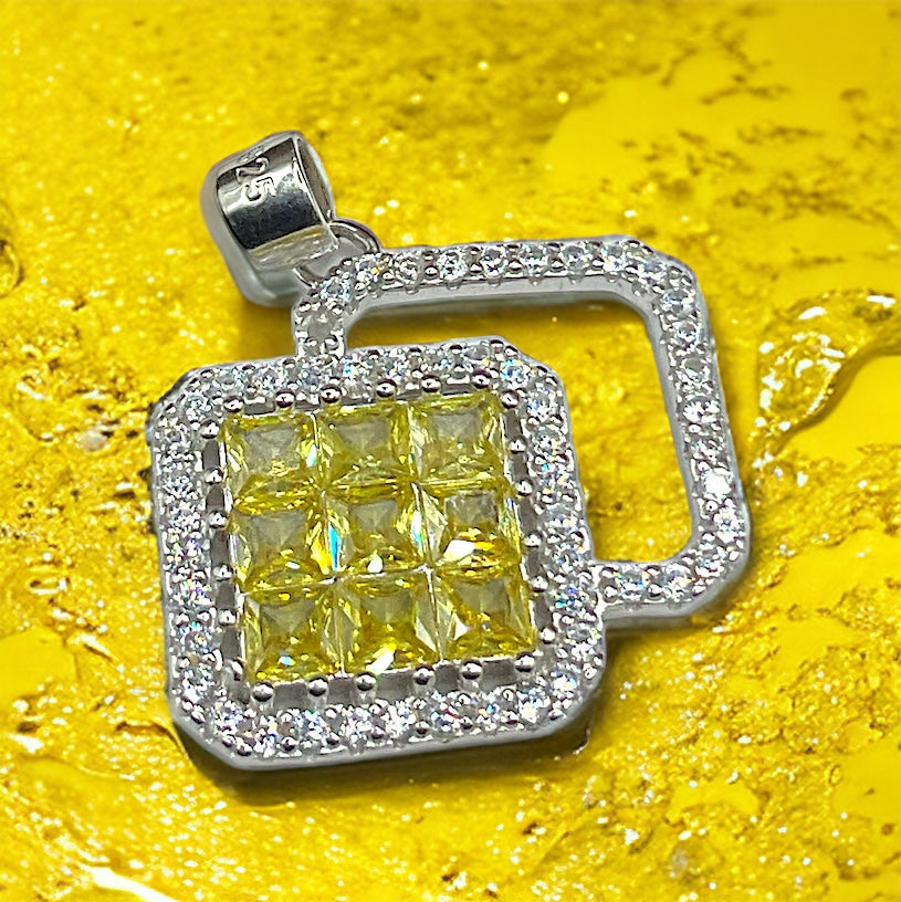 a yellow and white diamond pendant on a yellow background