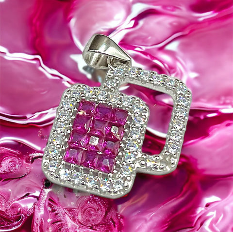 a close up of a pink diamond pendant