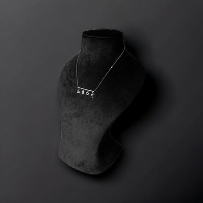 a necklace on a mannequin on a black background