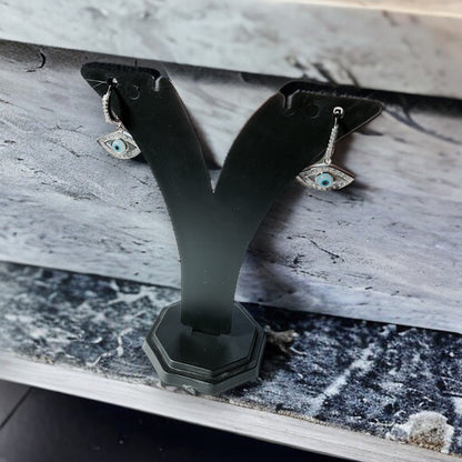 a close up of a pair of earrings on a bench