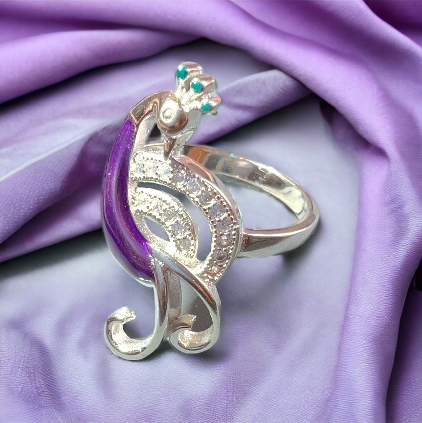 a close up of a ring on a purple cloth