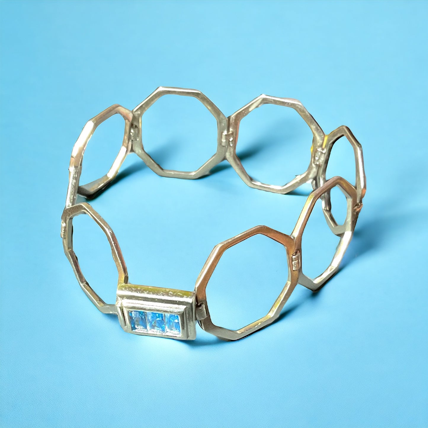 a close up of a bracelet on a blue background