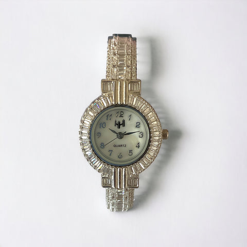 a watch is sitting on a white surface