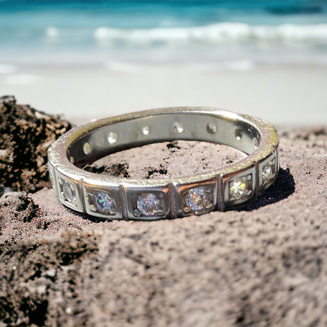 a ring sitting on top of a rock near the ocean