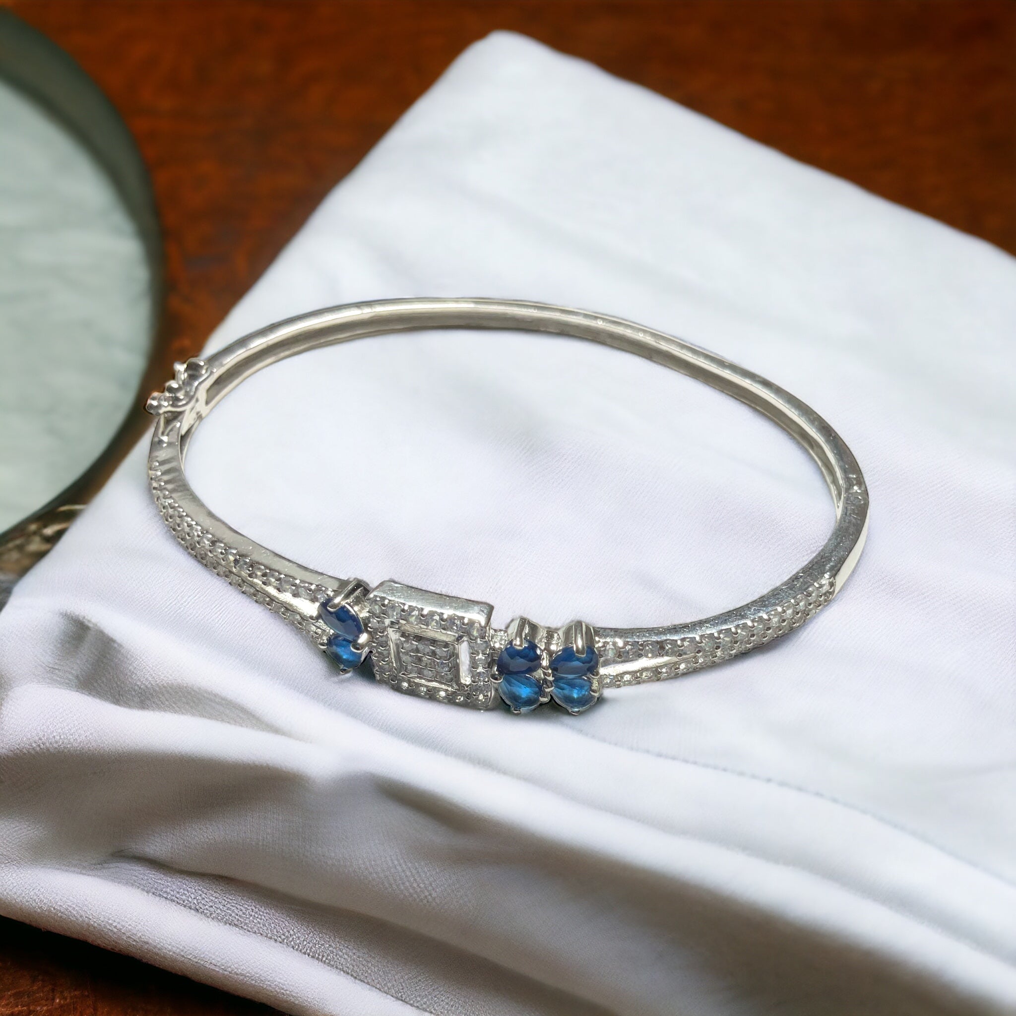 a silver bracelet with blue stones on it
