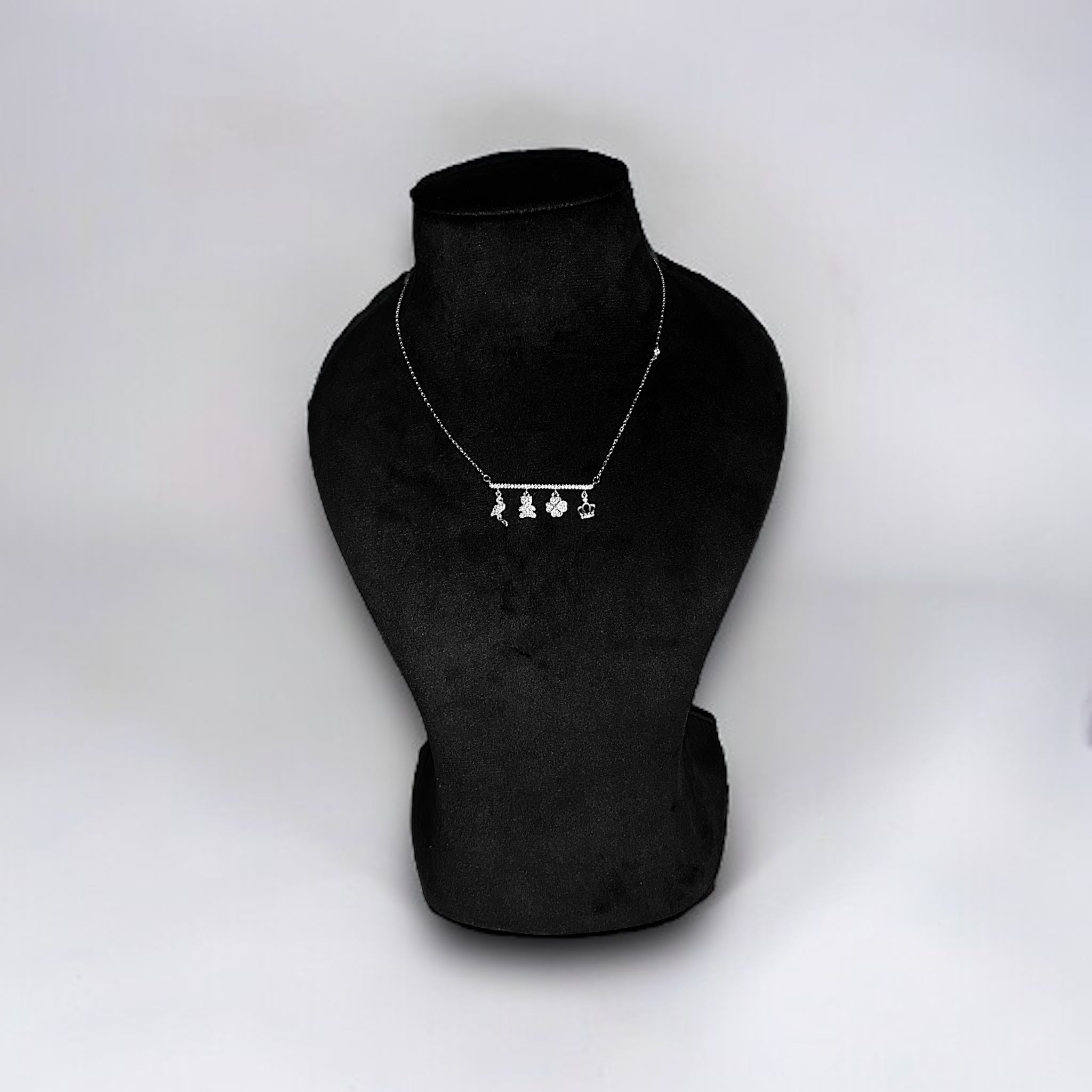 a necklace on a mannequin on a white background