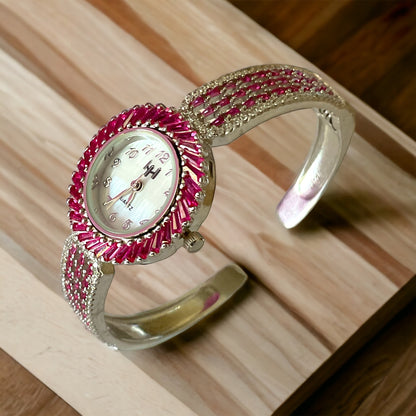 a close up of a watch on a wooden surface