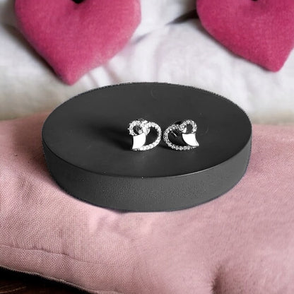 a pair of earrings sitting on top of a black box