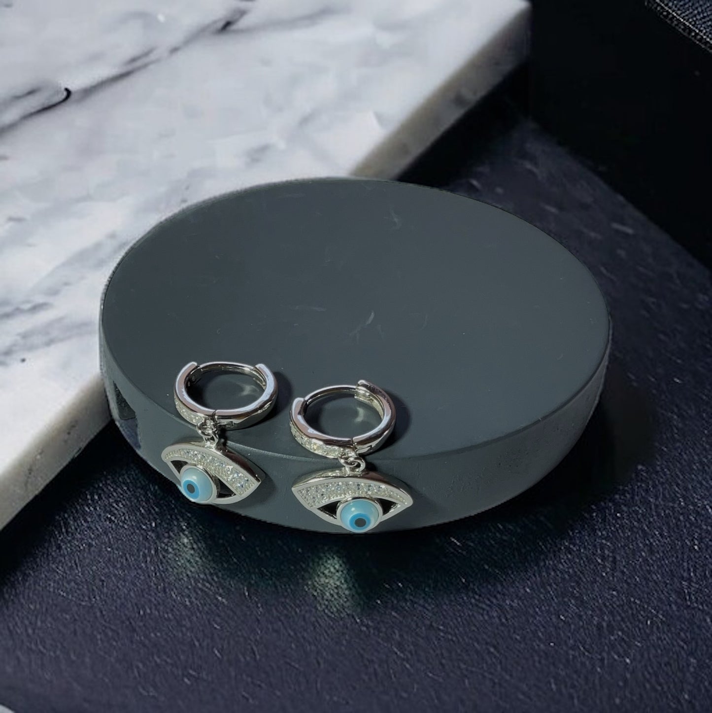 a pair of earrings sitting on top of a table