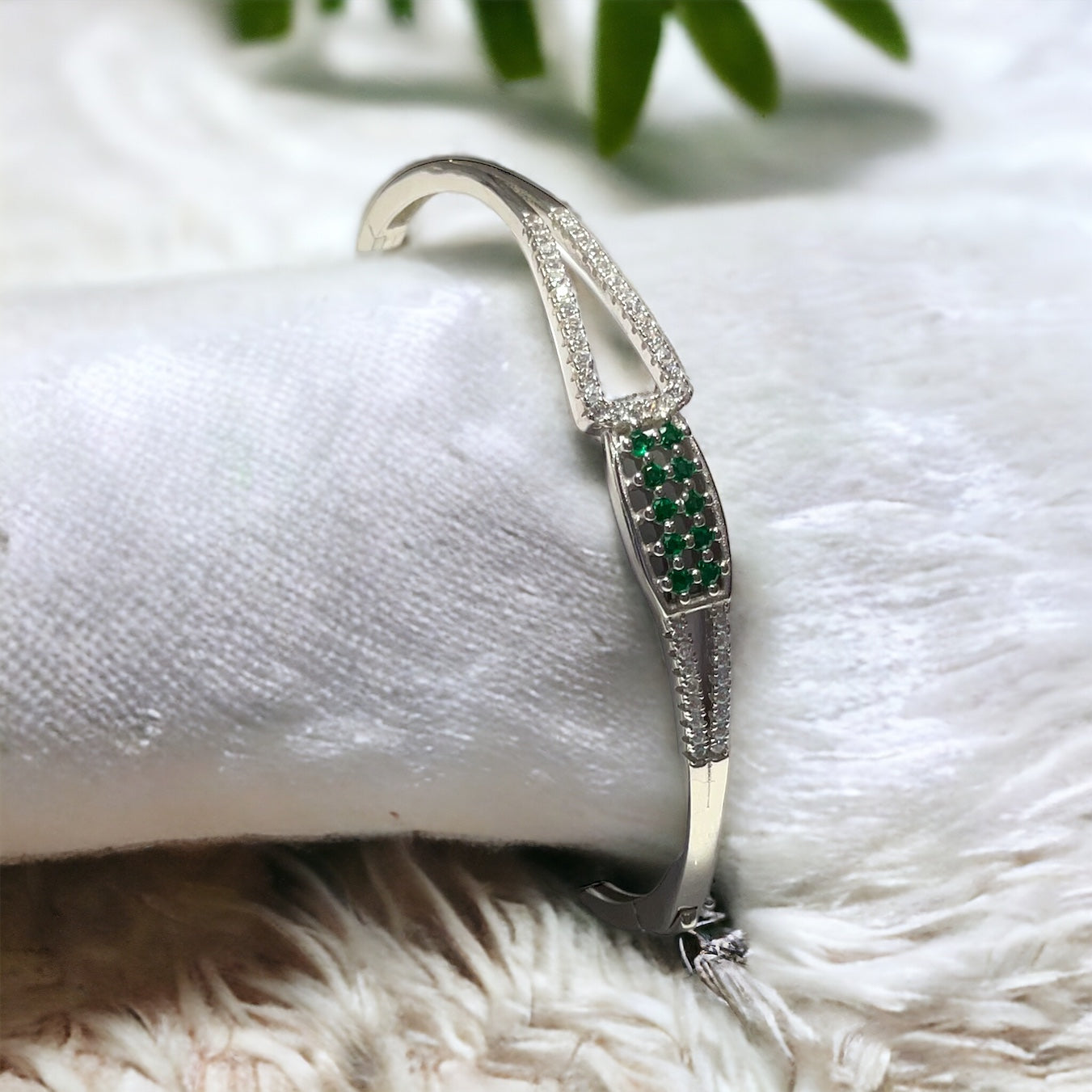 a close up of a bracelet on a white cloth