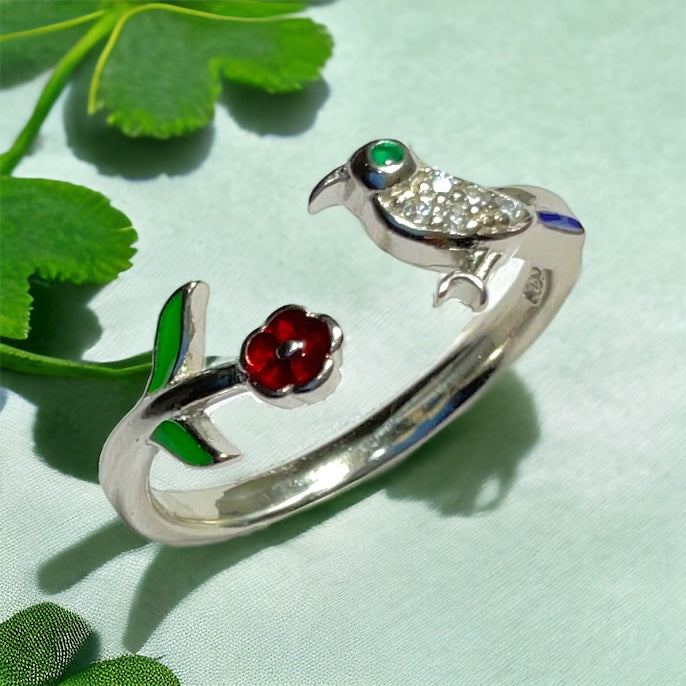 a close up of a ring with a bird on it