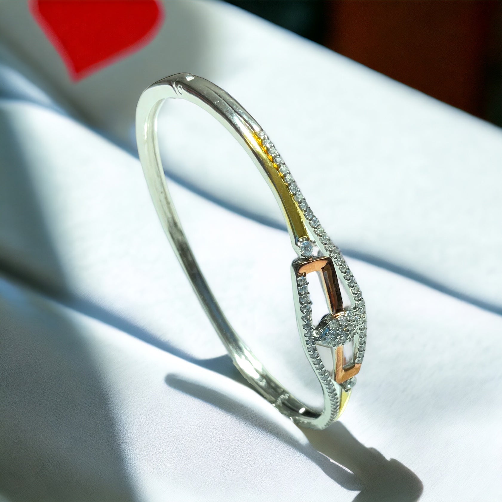 a close up of a bracelet on a white cloth