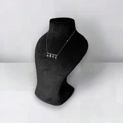 a black and white photo of a necklace on a mannequin