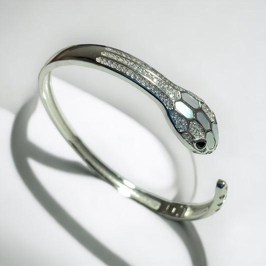 a silver bracelet with a snake on it