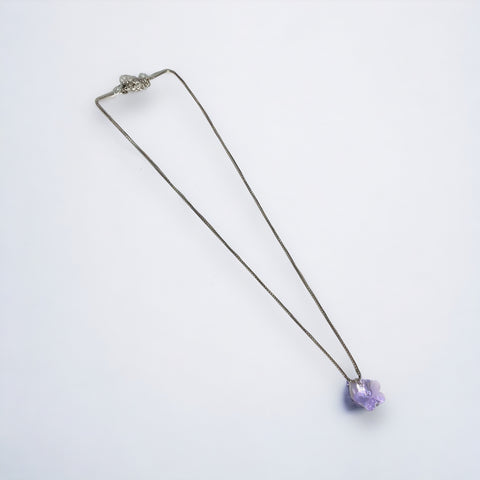 a necklace with a purple stone hanging from it